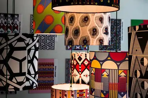 Hanging lampshades with vibrant, geometric, and abstract patterns in various colors and designs.